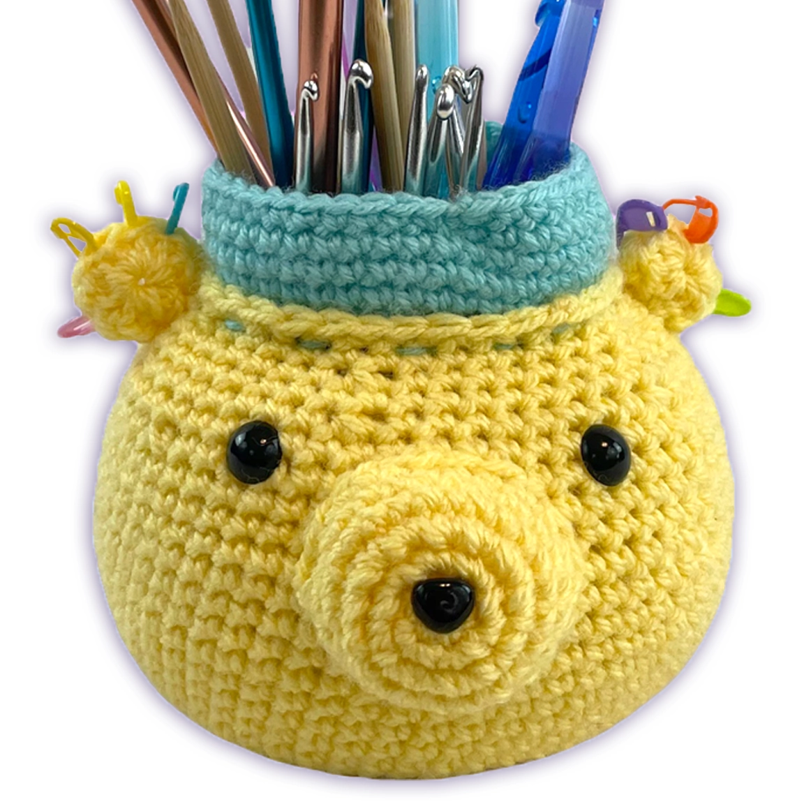 Crochet bear desk organizer filled with knitting and crochet tools, yellow amigurumi craft holder in use
