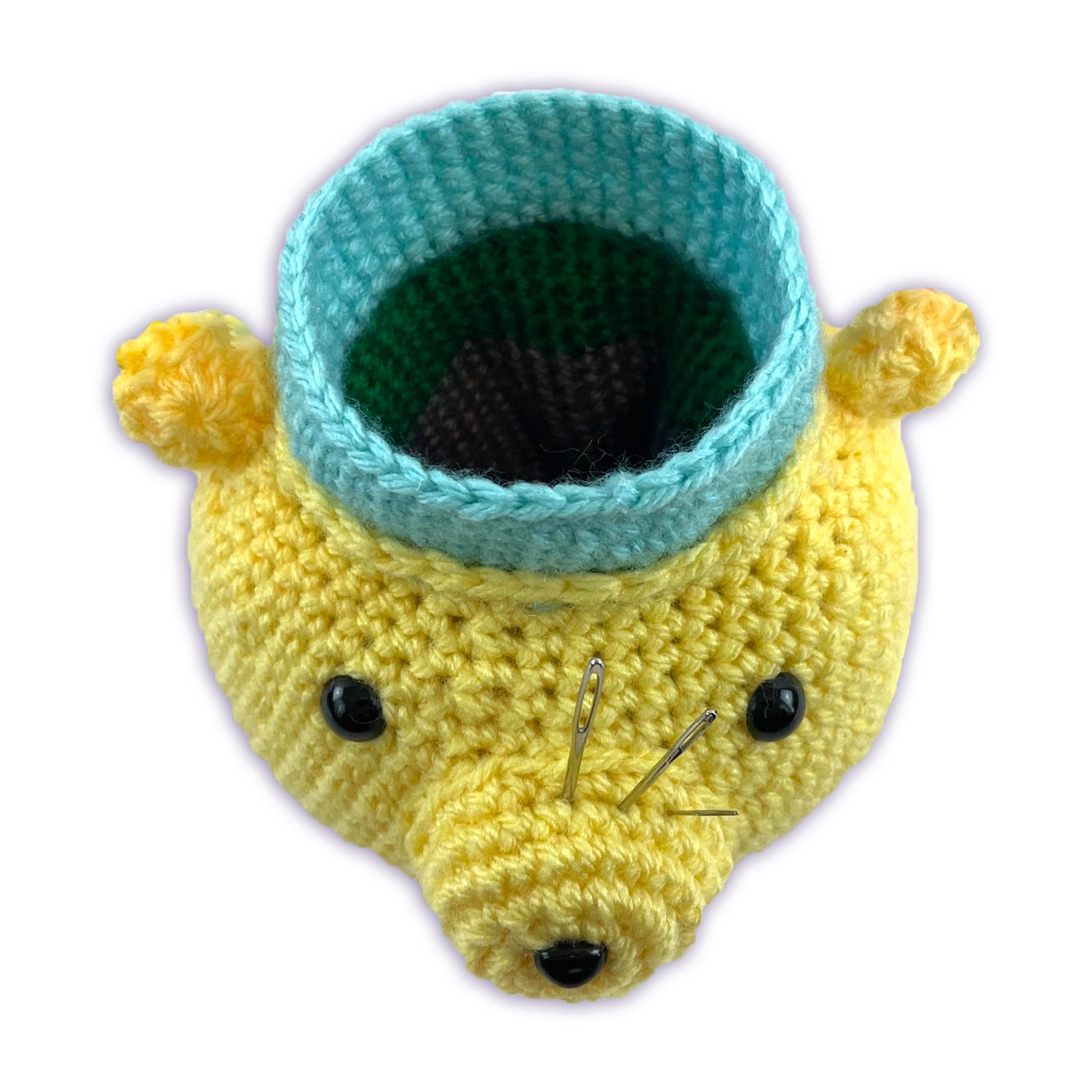 Interior view of crochet bear desk organizer, showing hollow storage compartment for craft tools
