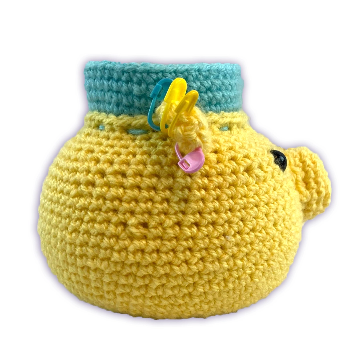 Side view of handmade crochet bear organizer, showing safety eye and nose pincushion detail
