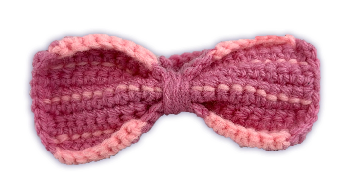 Close-up of Pancake crochet toon plush removable bow, hand-stitched detail