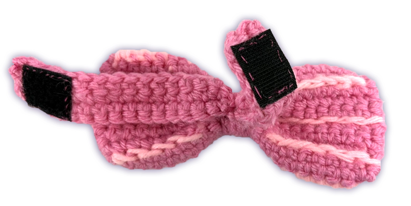 Close-up of Pancake crochet toon plush bow Velcro closure, hand-sewn detail
