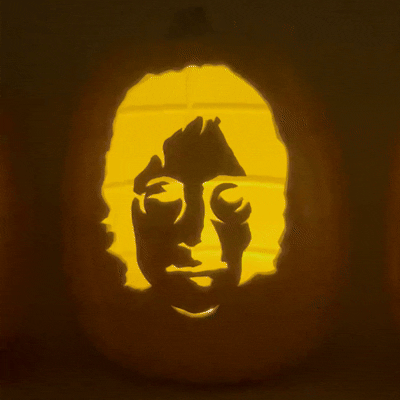 Hand-carved foam pumpkin featuring John Lennon's face, part of a Beatles Halloween pumpkin set