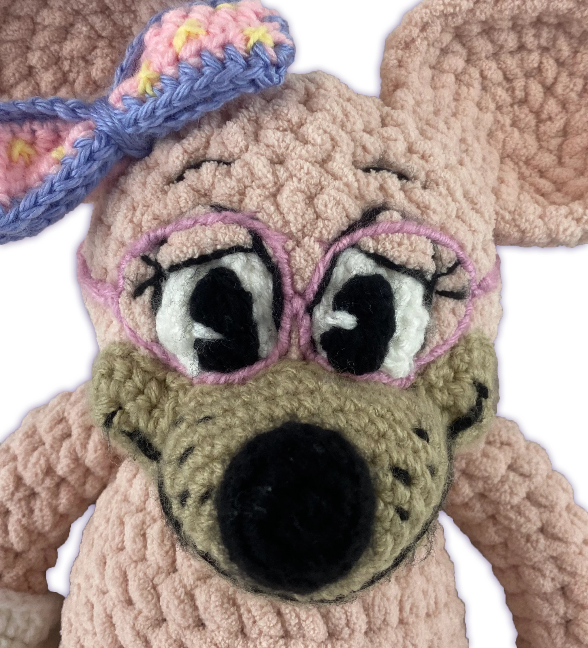Close-up of crochet mouse toon plush face, sewn-on glasses and bow detail