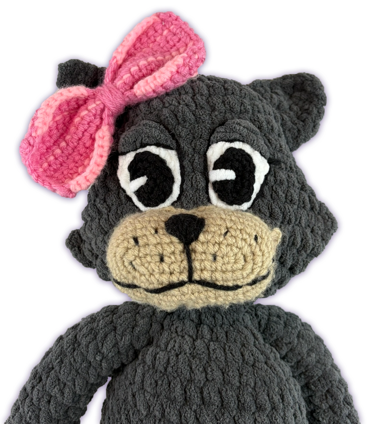 Close-up of Pancake crochet toon plush face, dark grey cat toon handmade features and pink bow