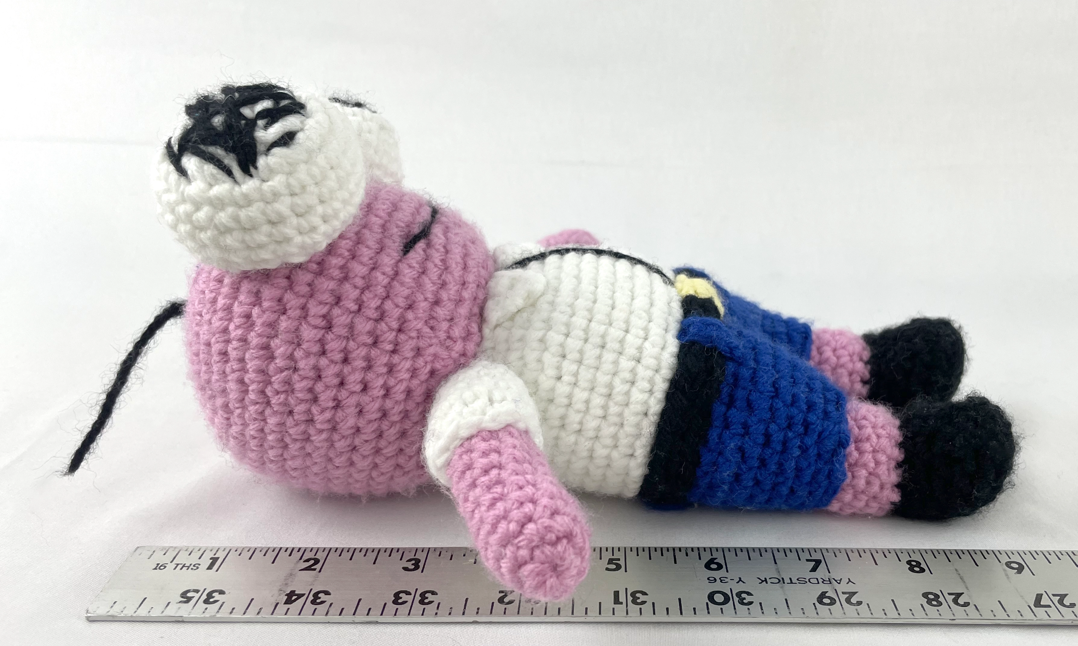 Crochet Pim plush next to yardstick showing size scale, handmade amigurumi measurement