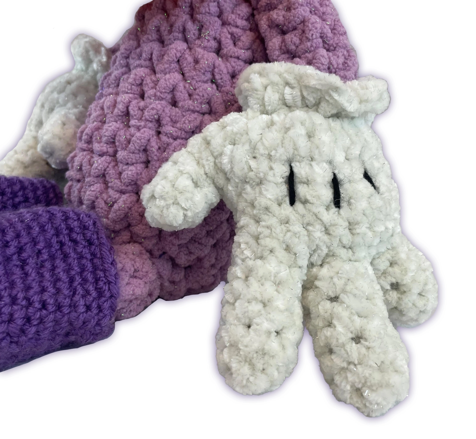 Close-up of Sofie the Duck crochet toon plush hands, chunky velvet-like white yarn detail