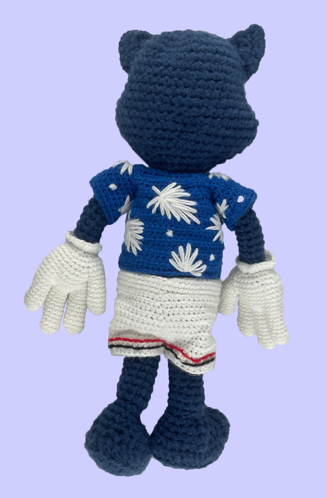 Back angle of handmade Toontown crochet plush: blue cat character in detailed blue floral shirt and white athletic shorts. Custom fan art plushie.