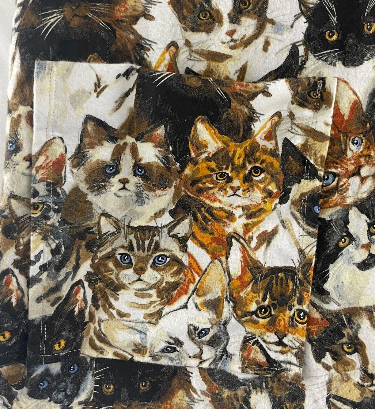 Close-up of cat dress pocket with matching fabric print
