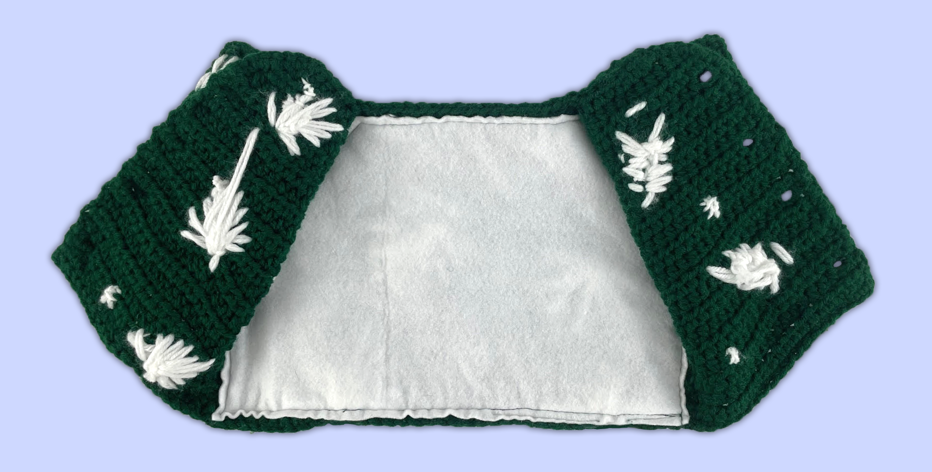 Inside view of a crocheted shirt for a stuffed animal, showing the soft felt lining attached to the inner back.