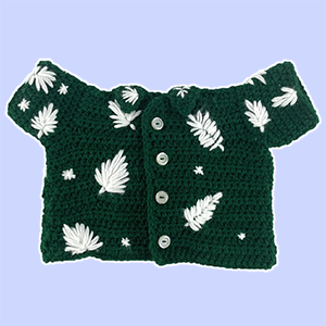 Green crochet shirt for a stuffed animal with buttons and leaves.