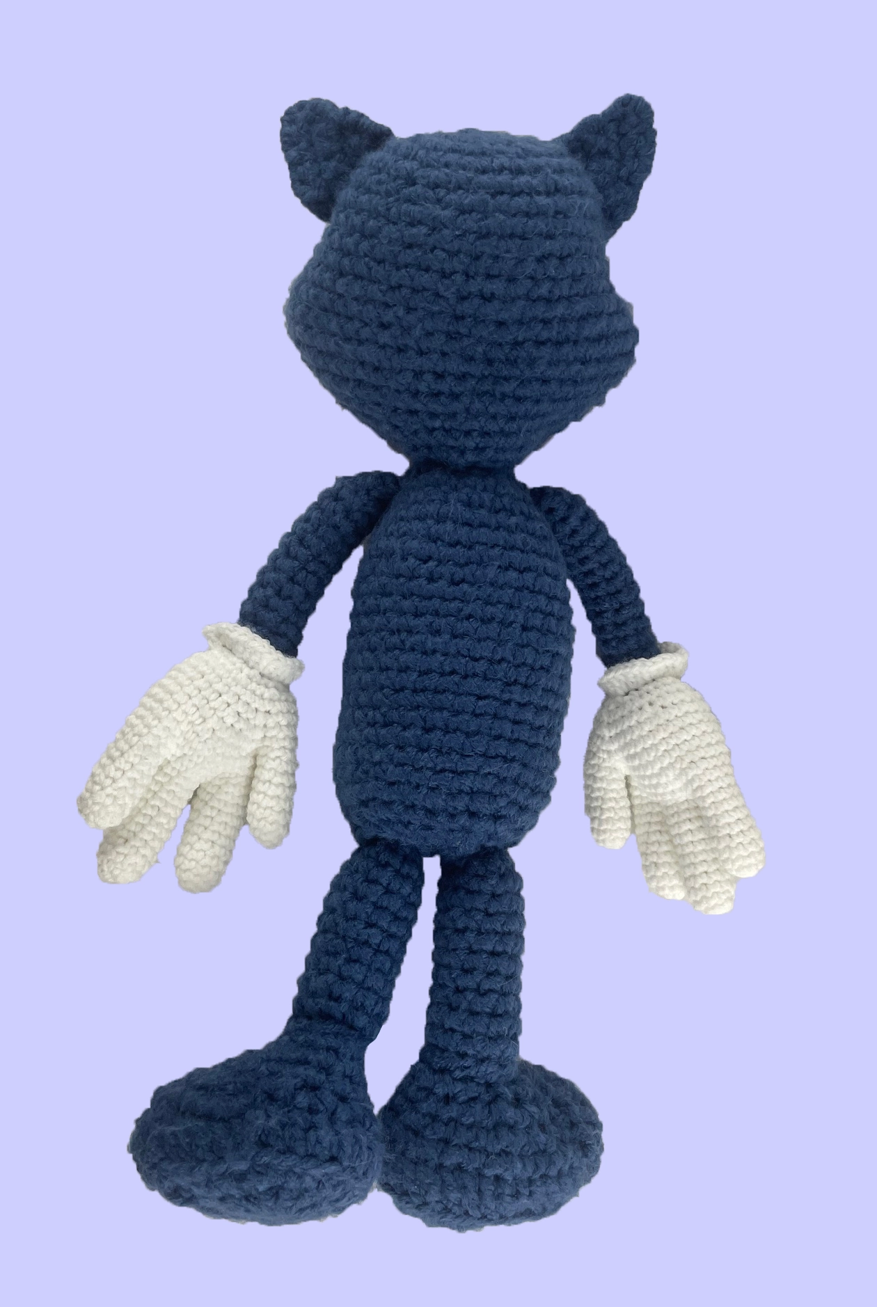Custom crochet Toontown blue cat plush toy, unclothed and laying face down. Shows detailed handmade yarn work on back and limbs.