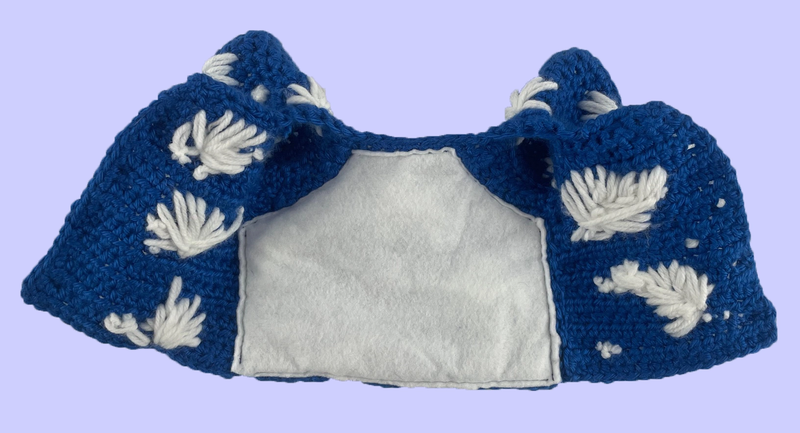 Interior view of handmade crochet plush shirt showing white felt lining used to cover inner stitching.