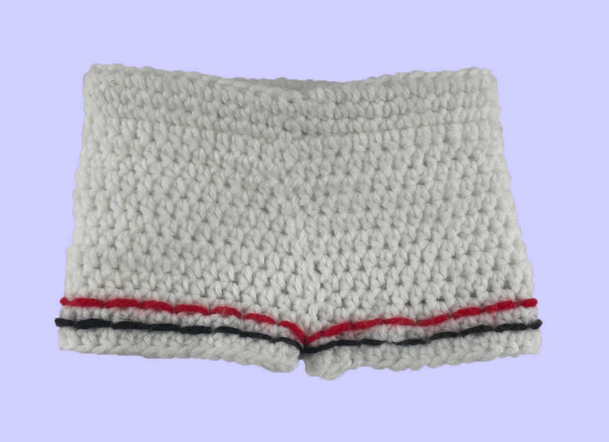 Back view of handmade crochet plush shorts showing white yarn and red and grey leg stripes.