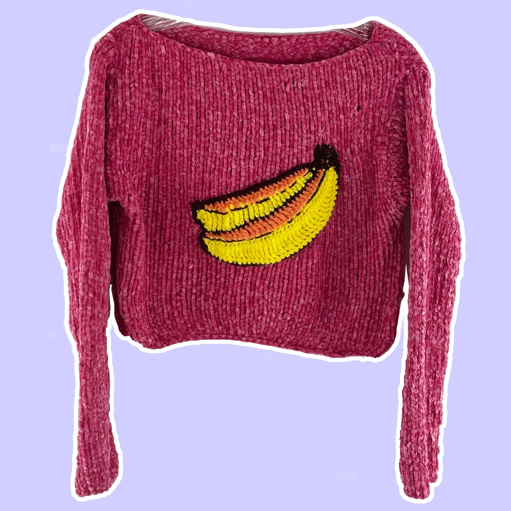 Pink knit long sleeve shirt with crochet banana applique on front