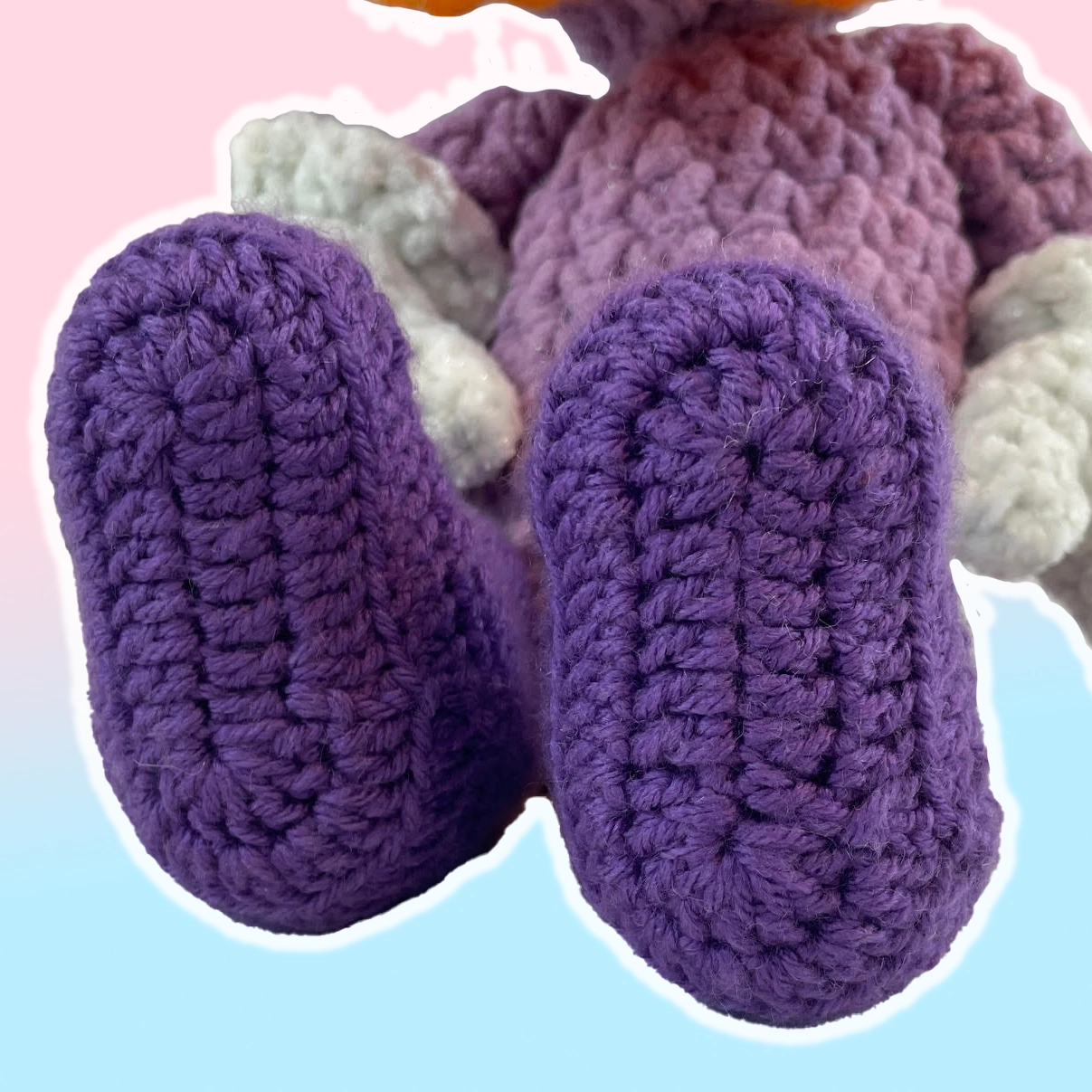 Detail of acrylic yarn purple boots on custom purple crochet Toontown duck plushie