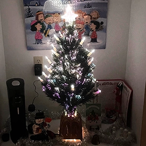 festive electric christmas tree at the bottom of my stairs